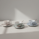 Delicate premium floral teacup set with white, sage green, and blue floral patterns and matching spoons, available at Mint LB Zahle Lebanon