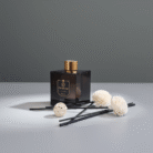 Modern smoky black reed diffuser with gold accents, decorative flower sticks, and black reeds, available at Mint LB Zahle Lebanon