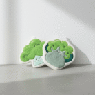 Adorable sage green kids bath gloves with playful broccoli characters, sage green kids bath gloves, available at Mint LB Zahle Lebanon