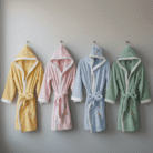 Pastel kids hooded bathrobe with yellow, pink, blue, and sage green options, embroidered hood faces and white trim, available at Mint LB Zahle Lebanon