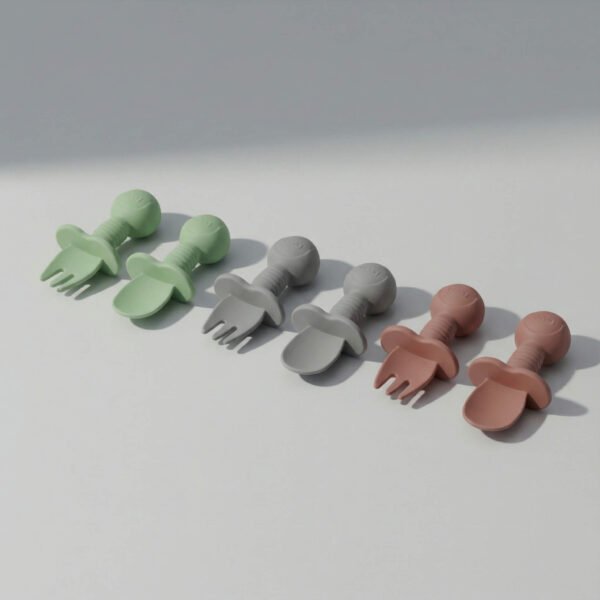 Three sets of silicone baby spoons and forks in sage green, gray, and pink with rounded handles and flared shield, sage green gray pink silicone baby cutlery set, available at Mint LB Zahle Lebanon