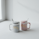 Elegant marble couple mugs set with gray and blush marble pattern, gold script, matching lids, and spoons, available at Mint LB Zahle Lebanon