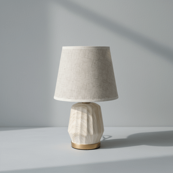 Modern cream linen table lamp with sculptured textured base and gold accent ring, available at Mint LB Zahle Lebanon